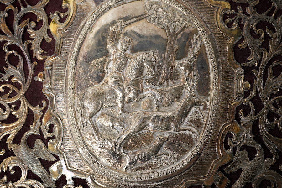 A white metal mounted rectangular desk folder, with beaded borders and pierced and decorated with scrolling foliage, birds and oval panels depicting figures at various pursuits, stamped '13', 30.6cm. Condition - poor to